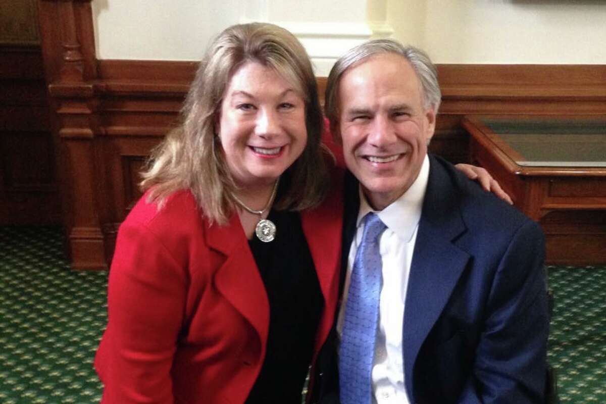 Leslie Recine, pictured with Gov. Greg Abbott, was appointed by the governor to help move forward a new bible-infused Texas curriculum for public schools.