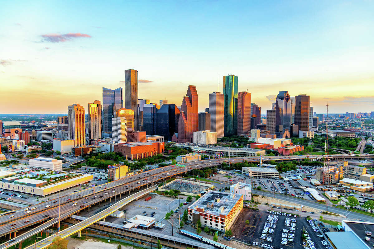 The sun illuminating the face of the buildings of downtown Houston.