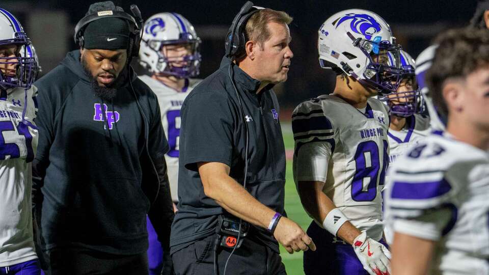 Ridge Point football coach Rick LaFavers meets with his team on the field in the first half of a high school football game against North Shore Friday, Nov. 22. 2024 at the Rig in Pearland.