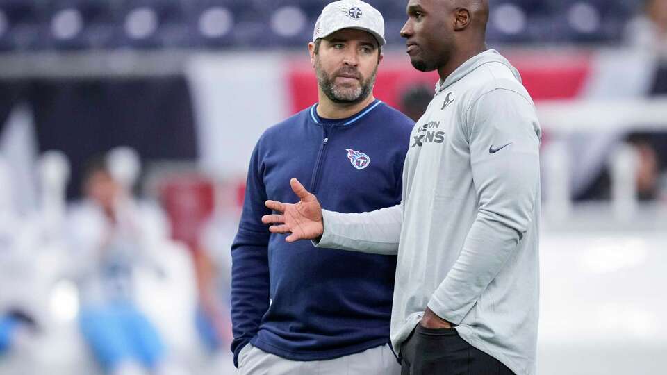 Tennessee Titans head coach Brian Callahan, left, talks to Houston Texans head coach DeMeco Ryans before an NFL football game against the Tennessee Titans Sunday, Nov. 24, 2024, in Houston.