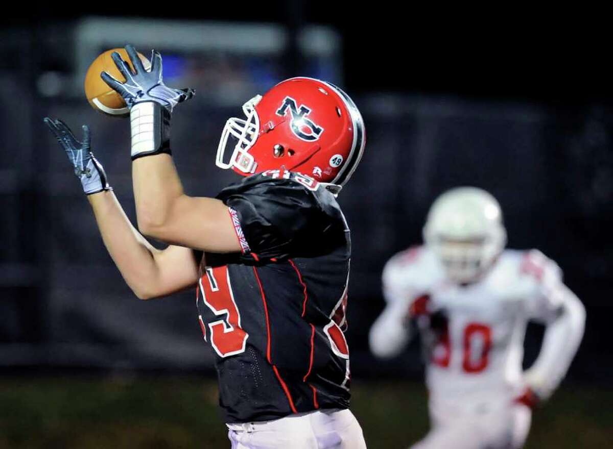 Kevin McDonough of New Canaan makes a catch during High School football game between Greenwich High School vs. New Canaan High School at New Canaan High School, Friday night, Nov. 5, 2010.