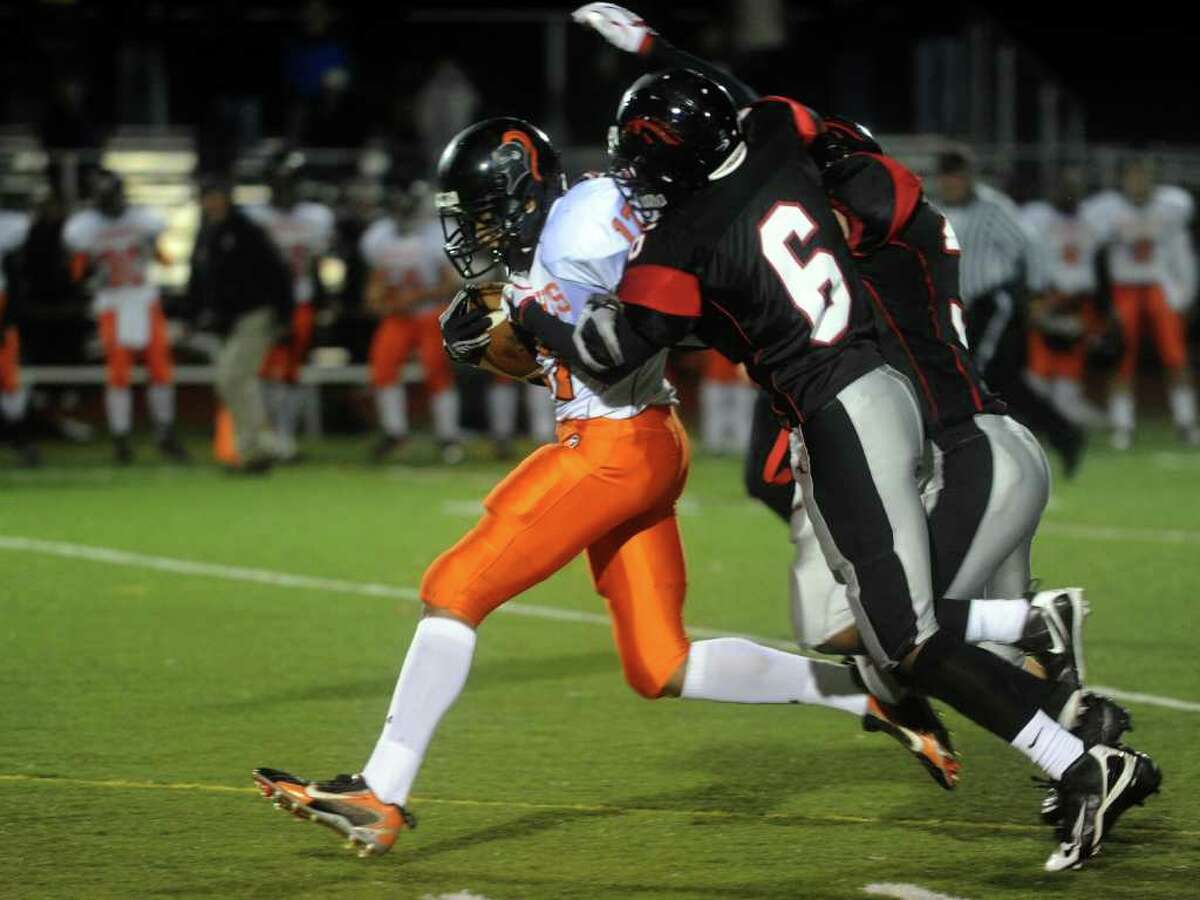 Stamford's Bryan Broderick is tackled by Warde's Terrell Walden during Friday's game at Fairfield Warde High School on November 5, 2010.