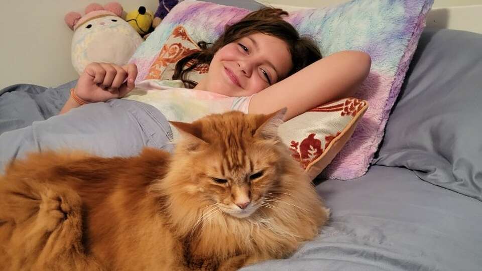 Isabelle 'Izzy' Anderson of New Milford has been keeping positive since she was diagnosed with high-risk metastatic neuroblastoma this past summer. Izzy is pictured here with her cat, Tao.