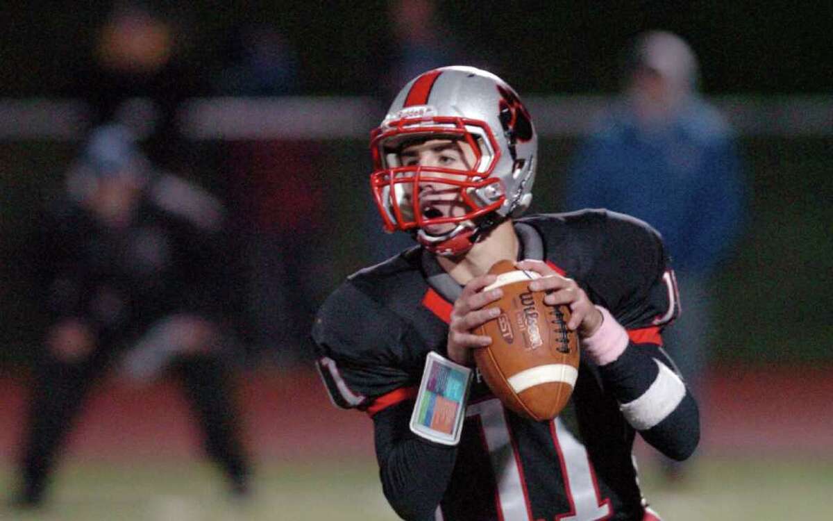 Pomperaug's 11, Kellen Croce sets up for a pass during the football game against Brookfield at Southbury High School Nov. 5, 2010.
