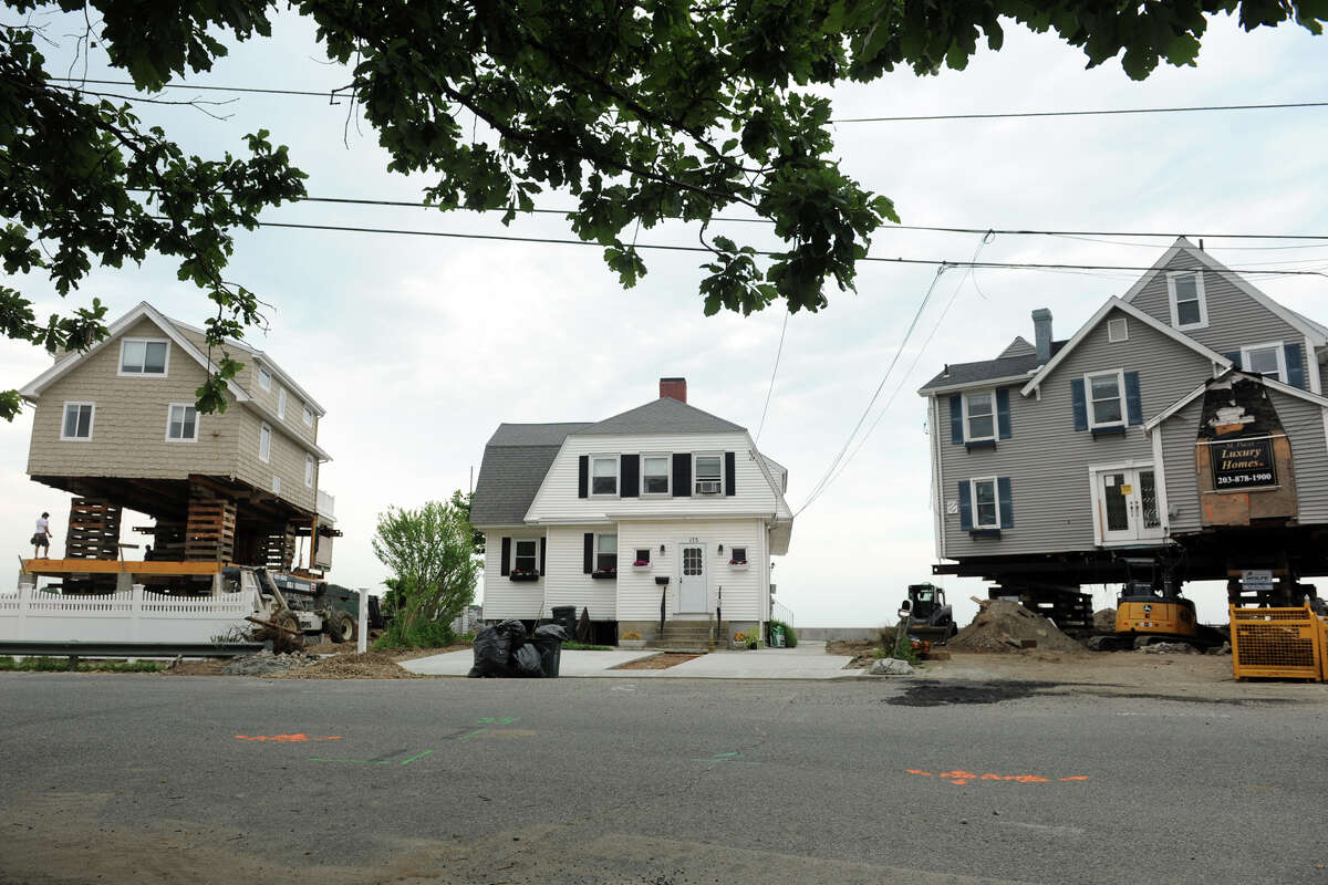 Houses being elevated along Hillside Avenue in Milford, Connecticut, in 2013 during the recovery from the 2012 storm Sandy. To comply with FEMA requirements for flood insurance coverage, Connecticut homeowners continue to install flood vents that allow water into basements and garage spaces, equalizing pressure on foundations to increase the odds against a structural failure.