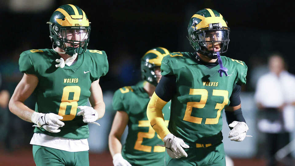 San Ramon Valley's Kaleb Pleis (8) and Texas A&M-bouMarco Jones (23).