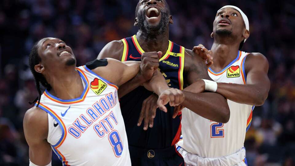 Golden State Warriors’ Draymond Green battles for position against Oklahoma City Thunder’s Jalen Williams and Shai Gilgeous-Alexander in 2nd quarter during NBA game at Chase Center in San Francisco on Wednesday, November 27, 2024.