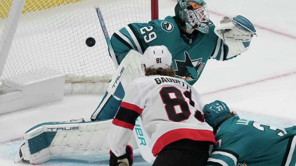 Ottawa Senators right wing Adam Gaudette, bottom left, scores a goal past San Jose Sharks goaltender Mackenzie Blackwood (29) during the third period of an NHL hockey game in San Jose, Calif., Wednesday, Nov. 27, 2024.