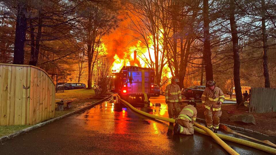 Firefighters battled a large house fire in south Weston on Thanksgiving evening, officials said. 