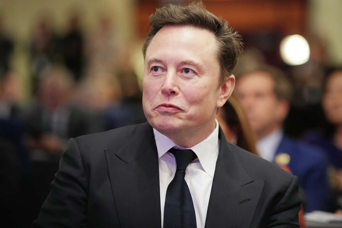 WASHINGTON, DC - NOVEMBER 13: Elon Musk listens as U.S. President-elect Donald Trump addresses a House Republicans Conference meeting at the Hyatt Regency on Capitol Hill on November 13, 2024 in Washington, DC. As is tradition with incoming presidents, Trump is traveling to Washington, DC to meet with U.S. President Joe Biden at the White House as well as meet with Republican congressmen on Capitol Hill. (Photo by Andrew Harnik/Getty Images)