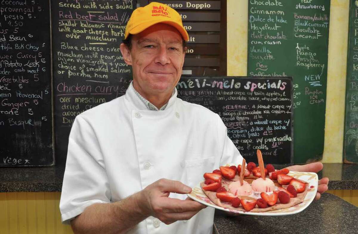 Marc Penvenne, owner of Meli-Melo, poses with a pink crepe in honor of Breast Cancer Awareness month at his shop on Greenwich Avenue on Monday, Oct. 25, 2010.