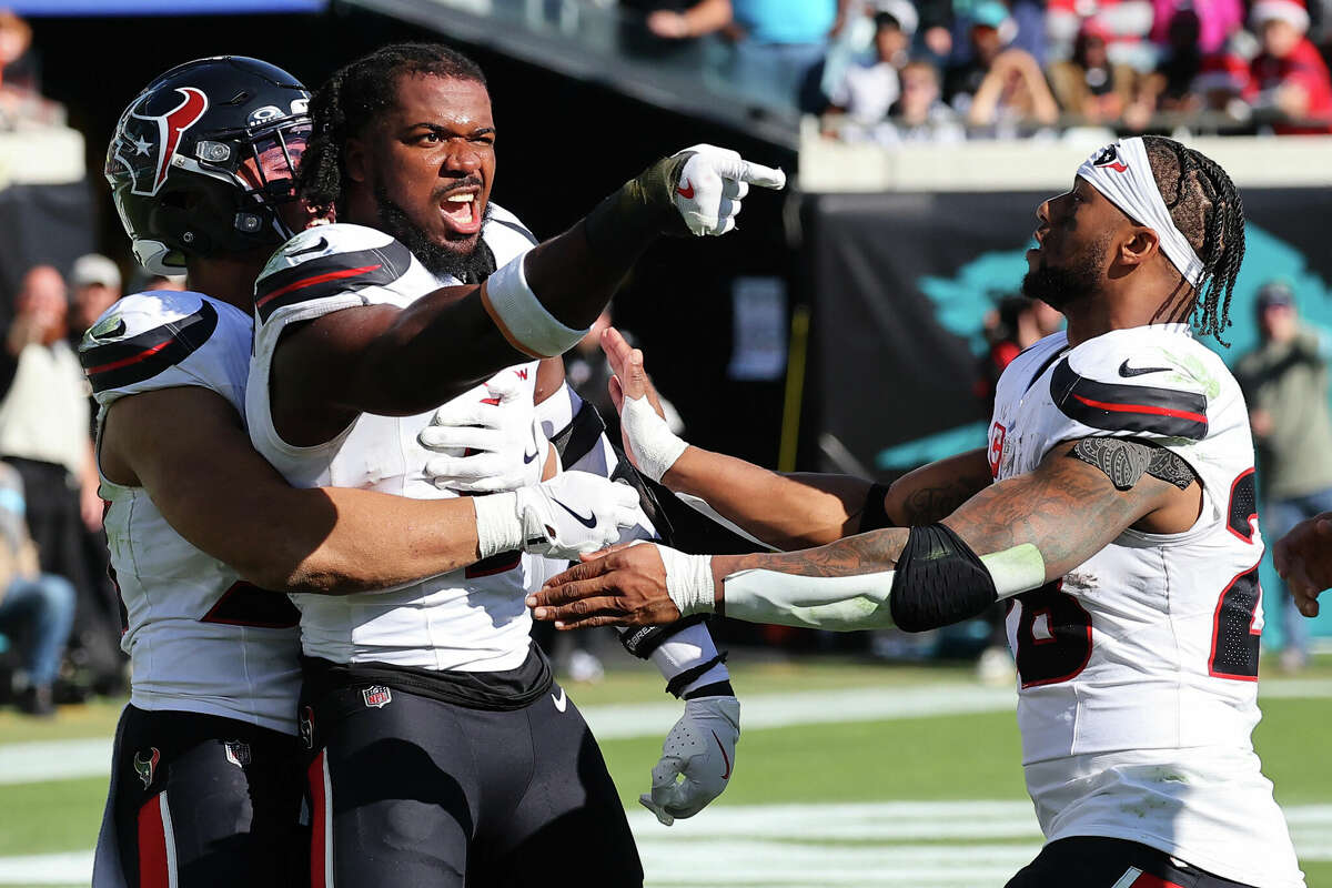 Azeez Al-Shaair of the Houston Texans points to the Jacksonville Jaguars bench after a fight and being ejected during the second quarter of a game at EverBank Stadium on December 01, 2024 in Jacksonville, Florida.