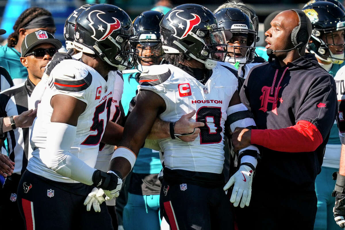 Houston Texans linebacker Azeez Al-Shaair (0) is escorted off the field by Texans head coach DeMeco Ryans and defensive end Will Anderson Jr. (51) after Al-Shaair hit Jacksonville Jaguars quarterback Trevor Lawrence as he was sliding, sparking an altercation between the two teams, during the first half of an NFL football game Sunday, Dec. 1, 2024, in Jacksonville, Fla.