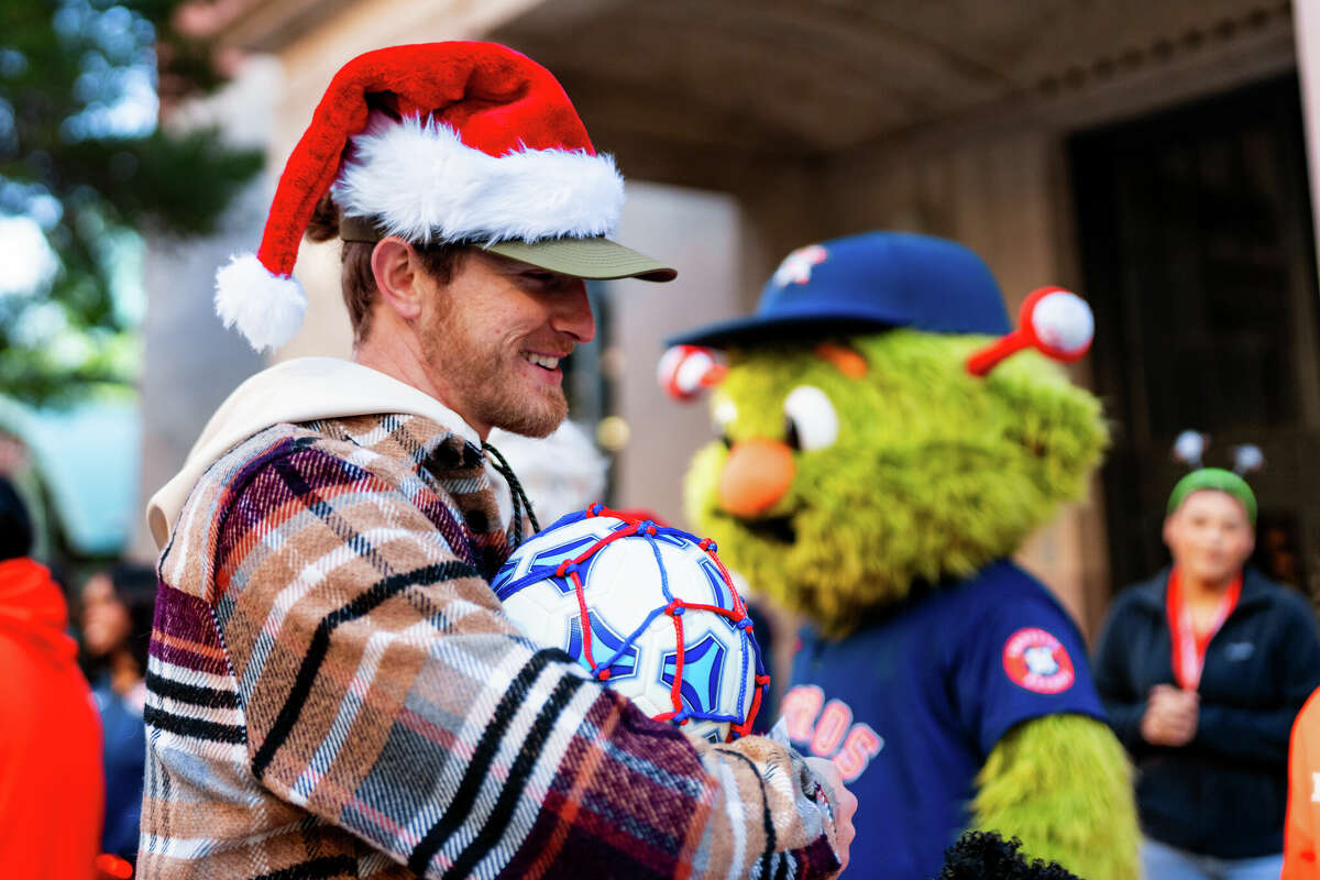 Houston Astros pitcher Josh Hader receives a soccer ball during his first-annual Christmas toy drive on Tuesday, Dec. 3 at Minute Maid Park. Hader's toy drive benefited BEAR Houston, an organization benefitting at-risk youths. 