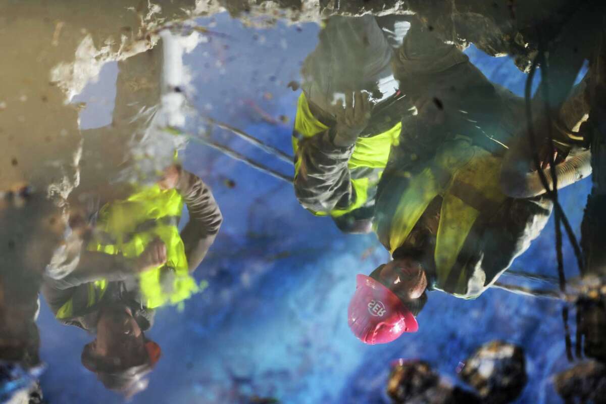 Workers with the West University Public Works repair a water line break at Buffalo Speedway and West Holcombe Boulevard, Wednesday, Jan. 17, 2024, in West University.