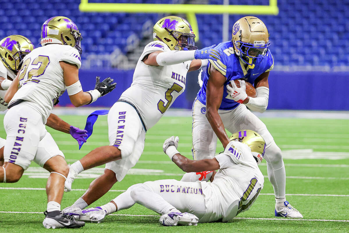 Alamo Heights' Michael Terry III (2) tries to fight though a tackle by Corpus Christi Miller's Corey Holmes (11) and Jayden Vela (5)bduring the first half of their Class 5A Division II regional semifinal football game at the Alamodome on Friday, Nov. 29, 2024 in San Antonio. Miller beat Alamo Heights 38-28.