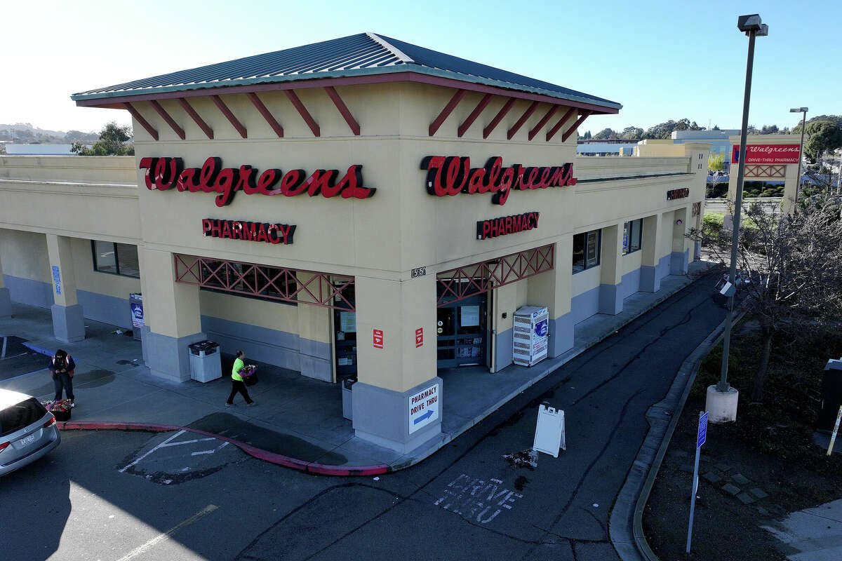 FILE: In an aerial view, a customer enters a Walgreens store on January 4, 2024 in San Pablo.  Shares of Walgreens stock fell sharply after the company reported better-than-expected first quarter earnings but plans to cut its quarterly dividend nearly in half. 