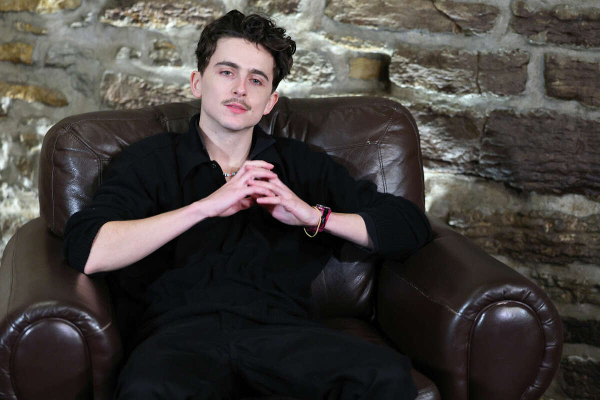 Timothee Chalamet answers questions from the media as he attends a screening of A Complete Unknown on December 05, 2024 in Minneapolis, Minn.