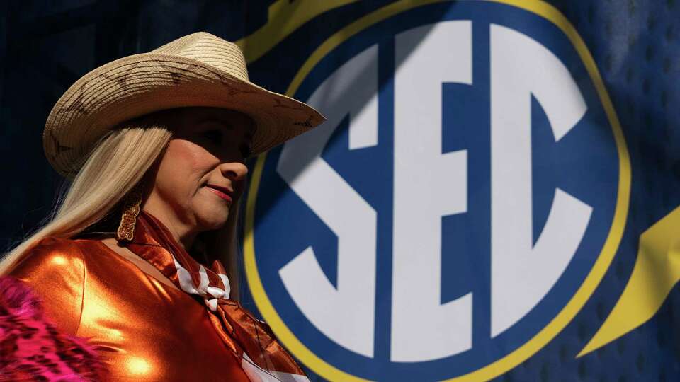 Texas fans head toward Mercedes-Benz Stadium for the SEC Championship college football game, Saturday, Dec. 7, 2024, in Atlanta.