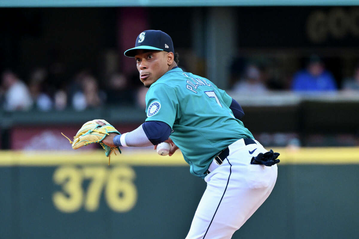  Jorge Polanco #7 of the Seattle Mariners looks to throw to first base during the first inning against the Houston Astros at T-Mobile Park on July 20, 2024 in Seattle, Washington. 