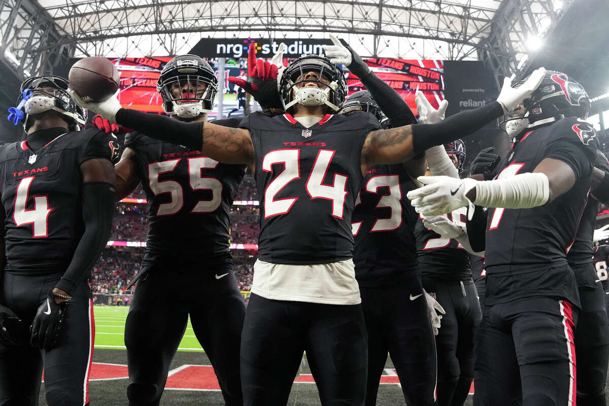 Houston Texans cornerback Derek Stingley Jr., center, celebrates after intercepting Miami Dolphins quarterback Tua Tagovailoa for the second time during the second half of an NFL football game, Sunday, Dec. 15, 2024, in Houston.