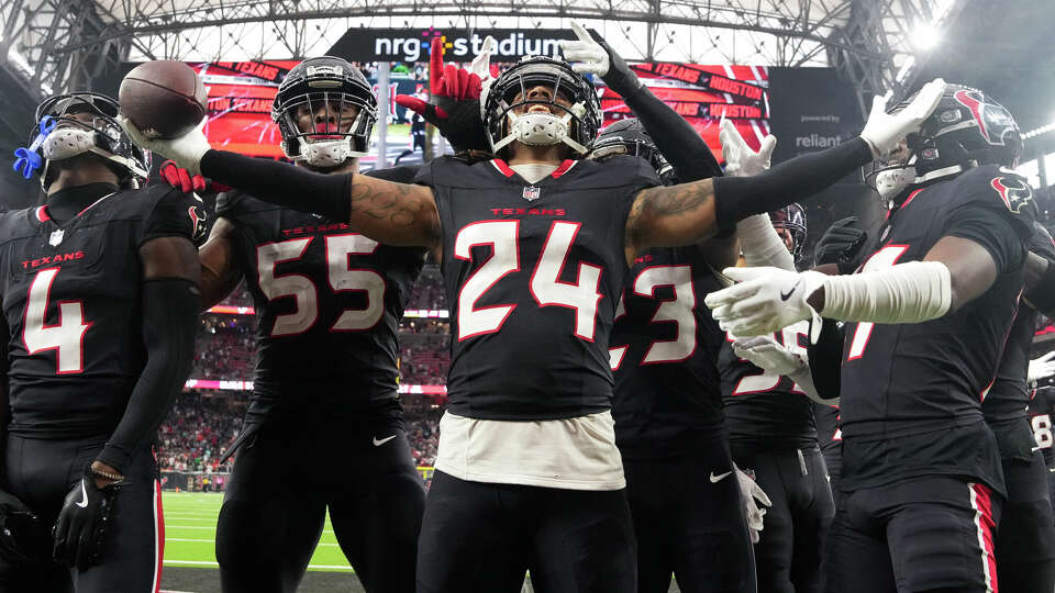 Houston Texans cornerback Derek Stingley Jr., center, celebrates after intercepting Miami Dolphins quarterback Tua Tagovailoa for the second time during the second half of an NFL football game, Sunday, Dec. 15, 2024, in Houston.