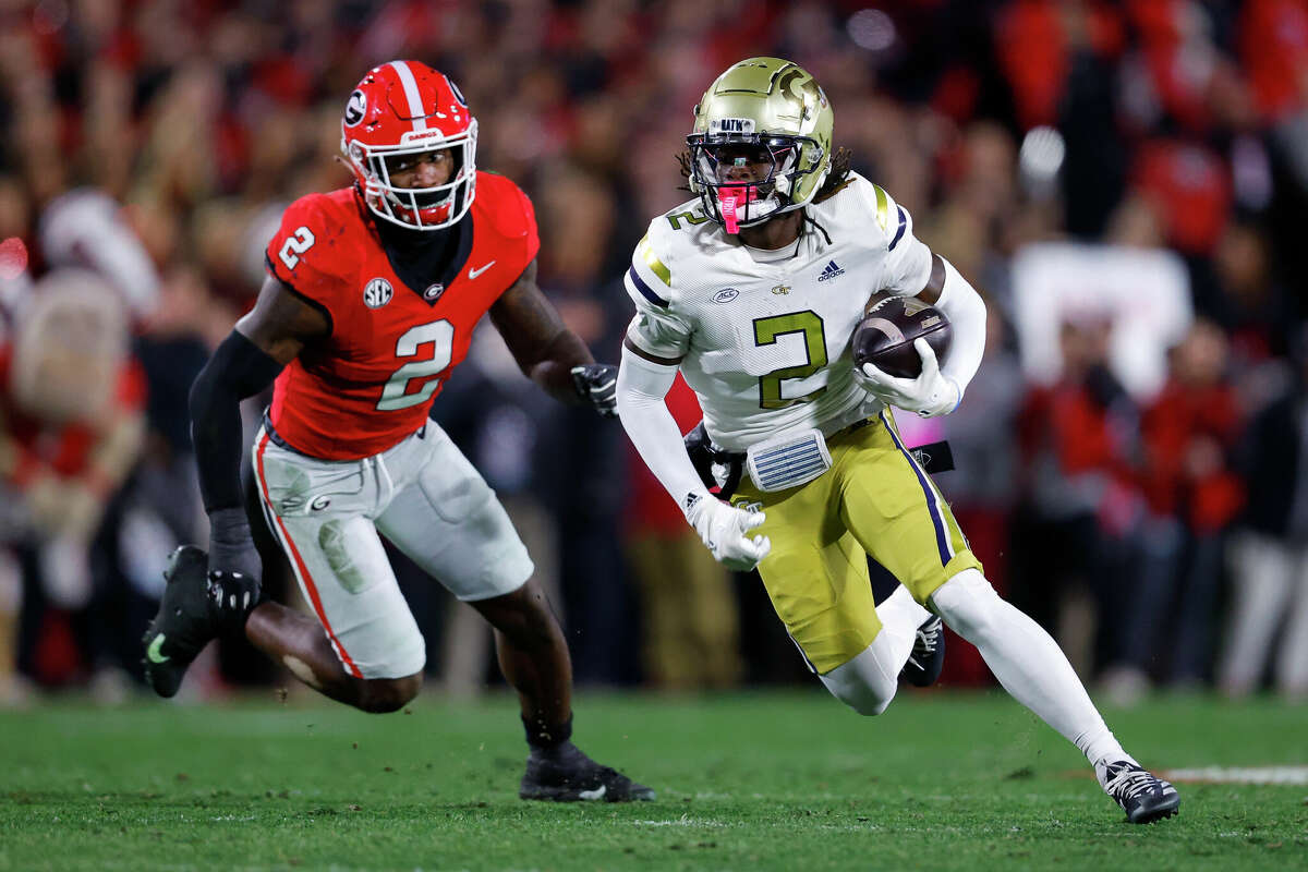 ATHENS, GEORGIA - NOVEMBER 29: Eric Singleton Jr. #2 of the Georgia Tech Yellow Jackets rushes as Smael Mondon Jr. #2 of the Georgia Bulldogs gives chase during the first quarter at Sanford Stadium on November 29, 2024 in Athens, Georgia. (Photo by Todd Kirkland/Getty Images)