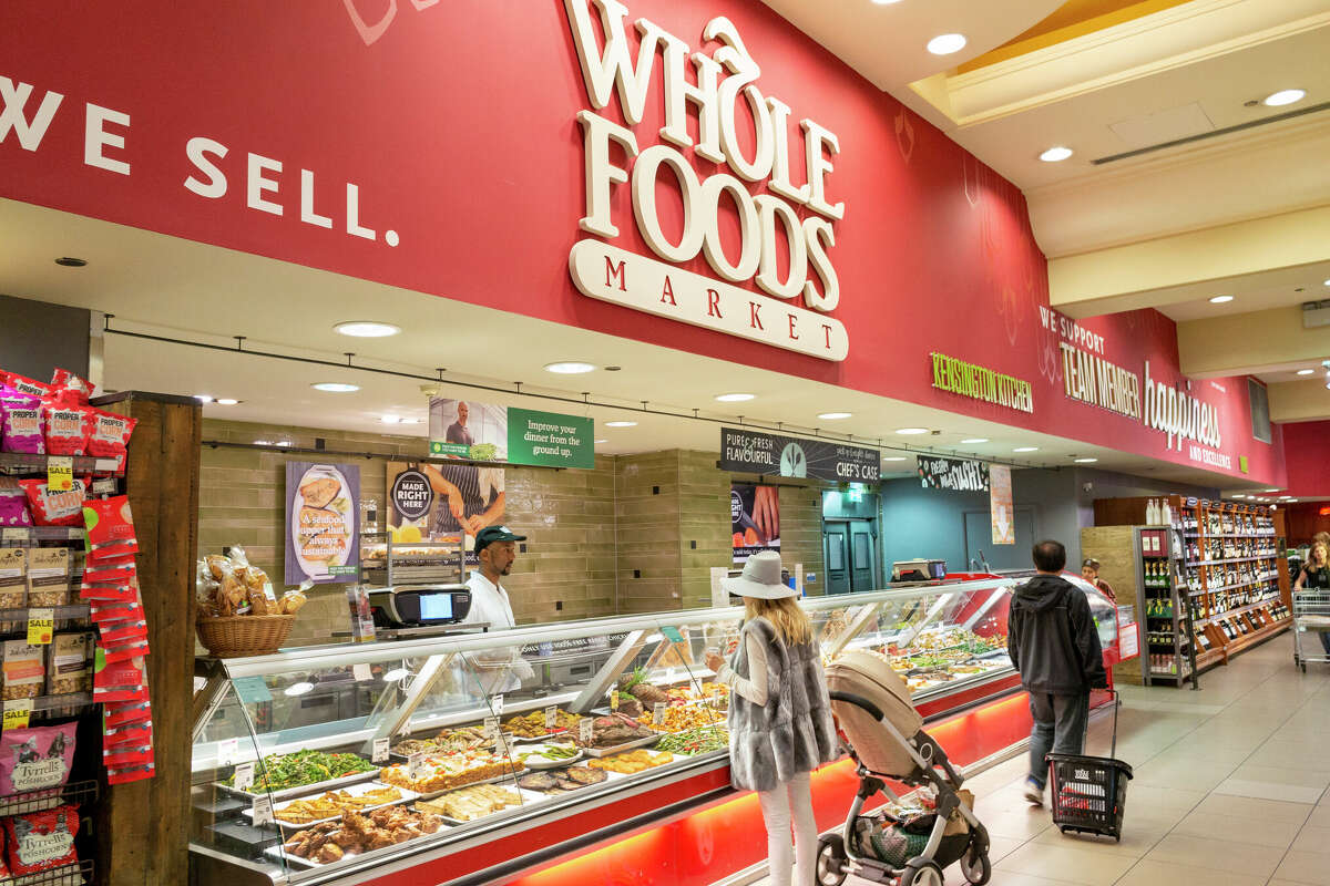 People shopping in Whole Foods Market in Kensington High Street, London, England, UK. 