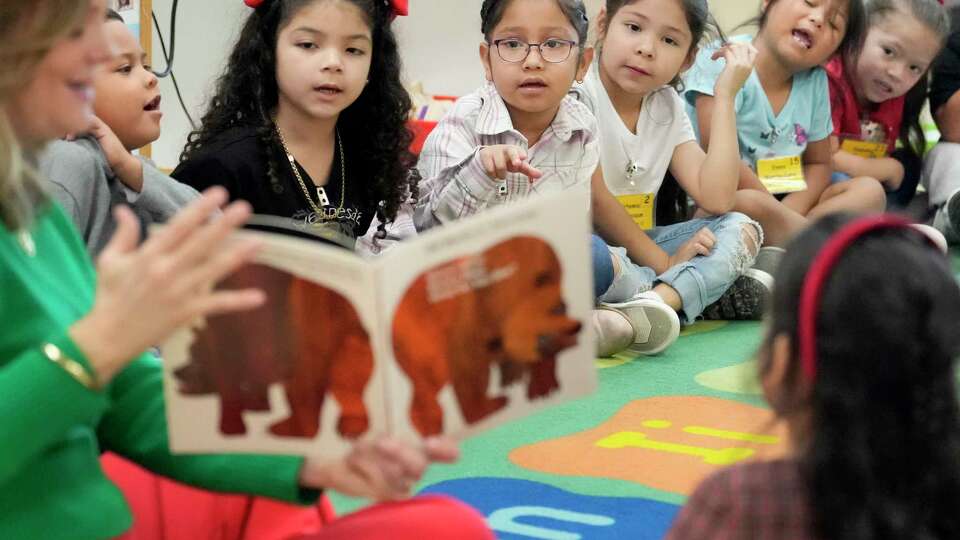 Courtney Meadows, Phillips 66 social impact manager, reads a book titled Brown Bear, Brown Bear, What Do You See? to a group of pre-K students at Farias Early Childhood Center, 515 Rittenhouse St., during a Barbara Bush Houston Literacy Foundation event Wednesday, Dec. 18, 2024, in Houston. The Foundation’s My Home Library program provided a bundle of six books, to nearly 400 children at the center. The event marked the 200,000th My Home Library (totaling 1.2 million books) donated since inception of the program in 2017.