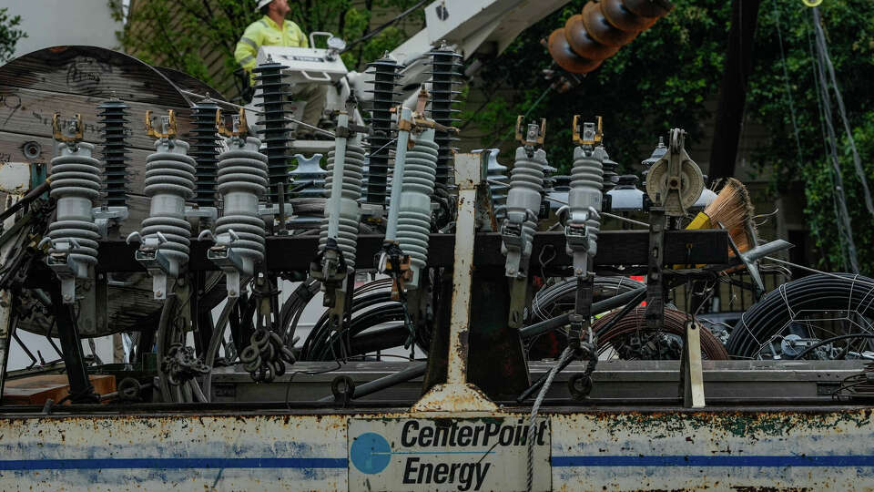 Linemen tend to fallen power lines in the East End neighborhood of Houston, days after Hurricane Beryl made landfall, on Thursday, July 11, 2024 in Houston.