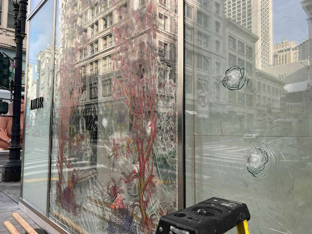 Bullet holes in glass windows of the San Francisco Dior store in Union Square. A man believed to have been a security guard at the store was shot and killed by police. Police sought him in connection with an alleged assault a day earlier. 