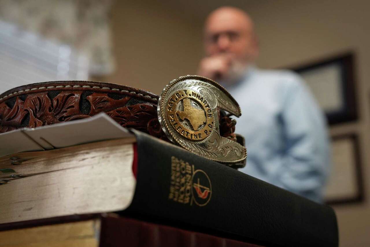 A belt belonging to Reverend Brian Wharton sits on top of his Bible as he talks about his career as a police officer Sunday, Dec. 8, 2024, at Onalaska First United Methodist Church in Onalaska.