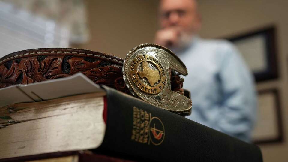 A belt belonging to Reverend Brian Wharton sits on top of his Bible as he talks about his career as a police officer Sunday, Dec. 8, 2024, at Onalaska First United Methodist Church in Onalaska.