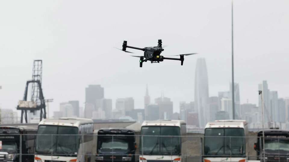 A San Francisco Police Department DJI Matrice 30T drone is seen against the skyline as it is flown at Pier 96 on Thursday, December 12, 2024 in San Francisco, Calif.