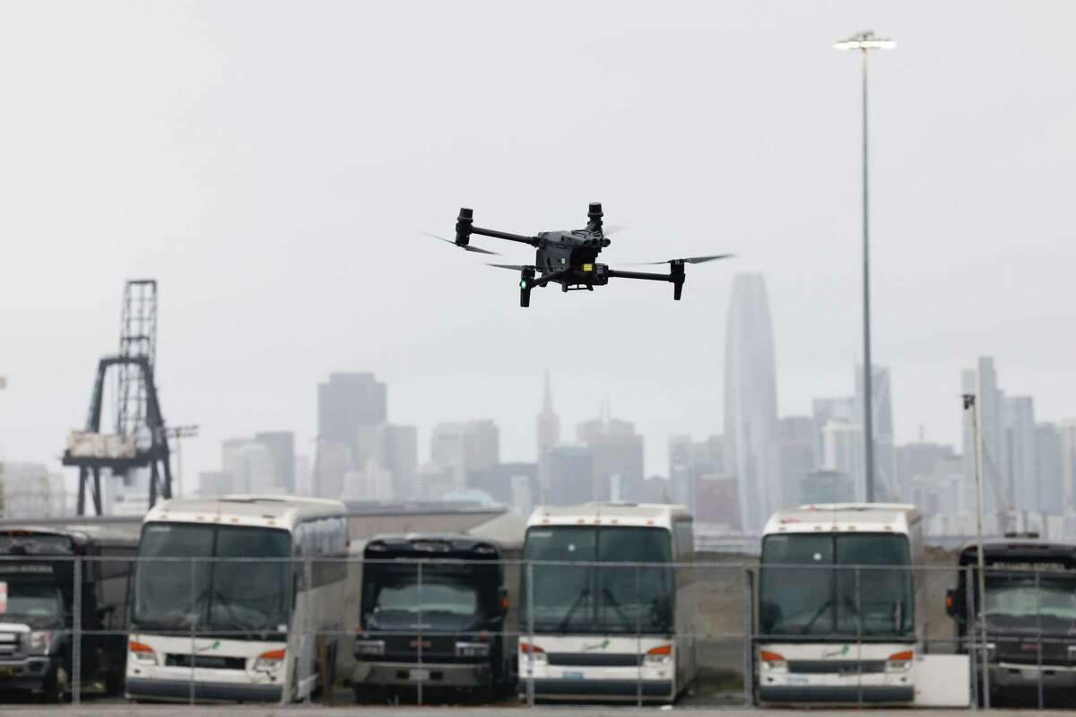 A San Francisco Police Department DJI Matrice 30T drone is seen against the skyline as it is flown at Pier 96 on Thursday, December 12, 2024 in San Francisco, Calif.