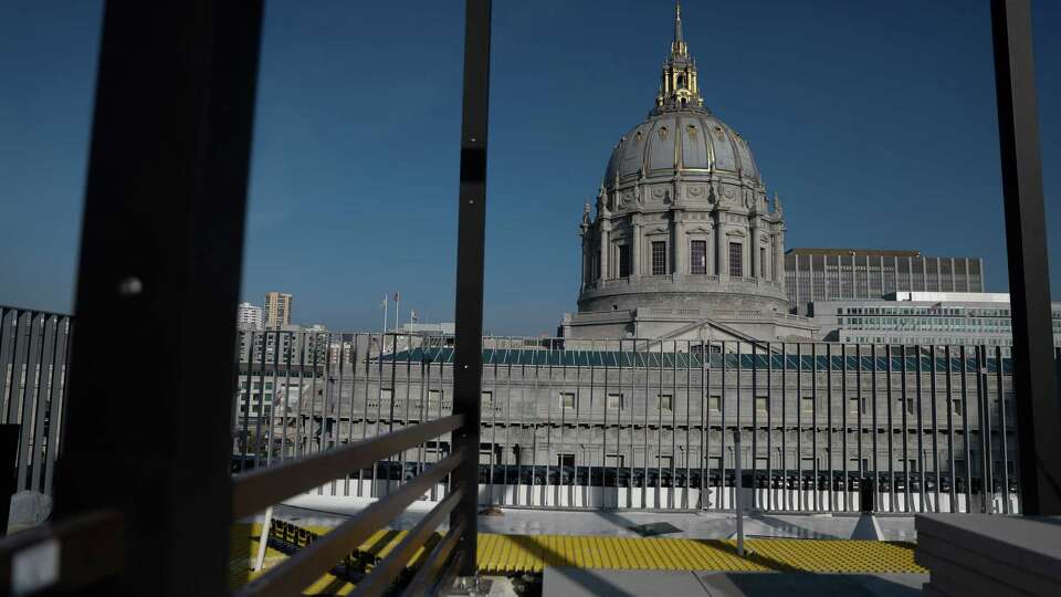 A view if City Hall is seen from a roof top trellis being installed at The Kelsey Civic Center on Wednesday, December 11, 2024 in San Francisco, Calif.