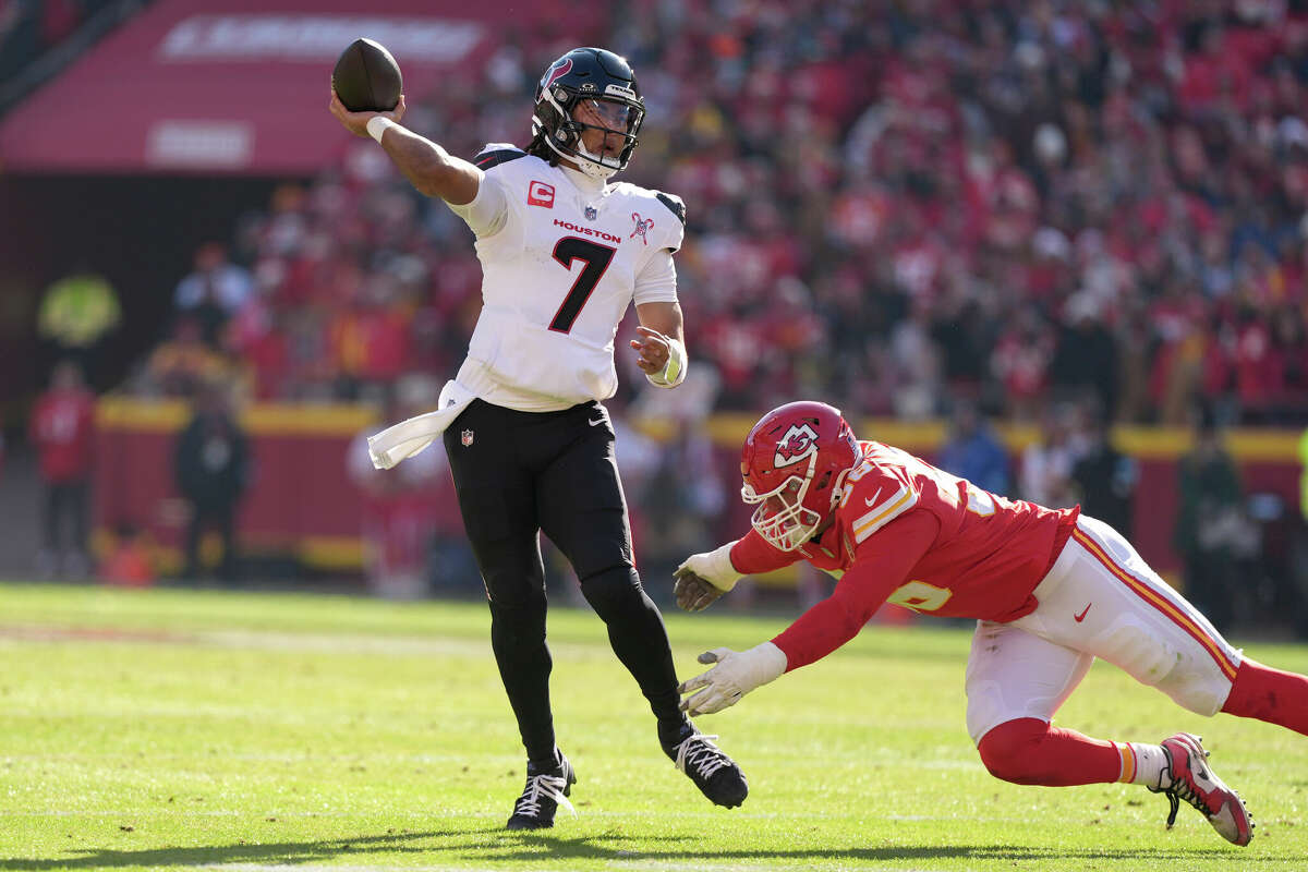 Houston Texans quarterback C.J. Stroud (7) throws a touchdown pass under pressure from Kansas City Chiefs defensive end George Karlaftis during the first half of an NFL football game Saturday, Dec. 21, 2024, in Kansas City, Mo. 