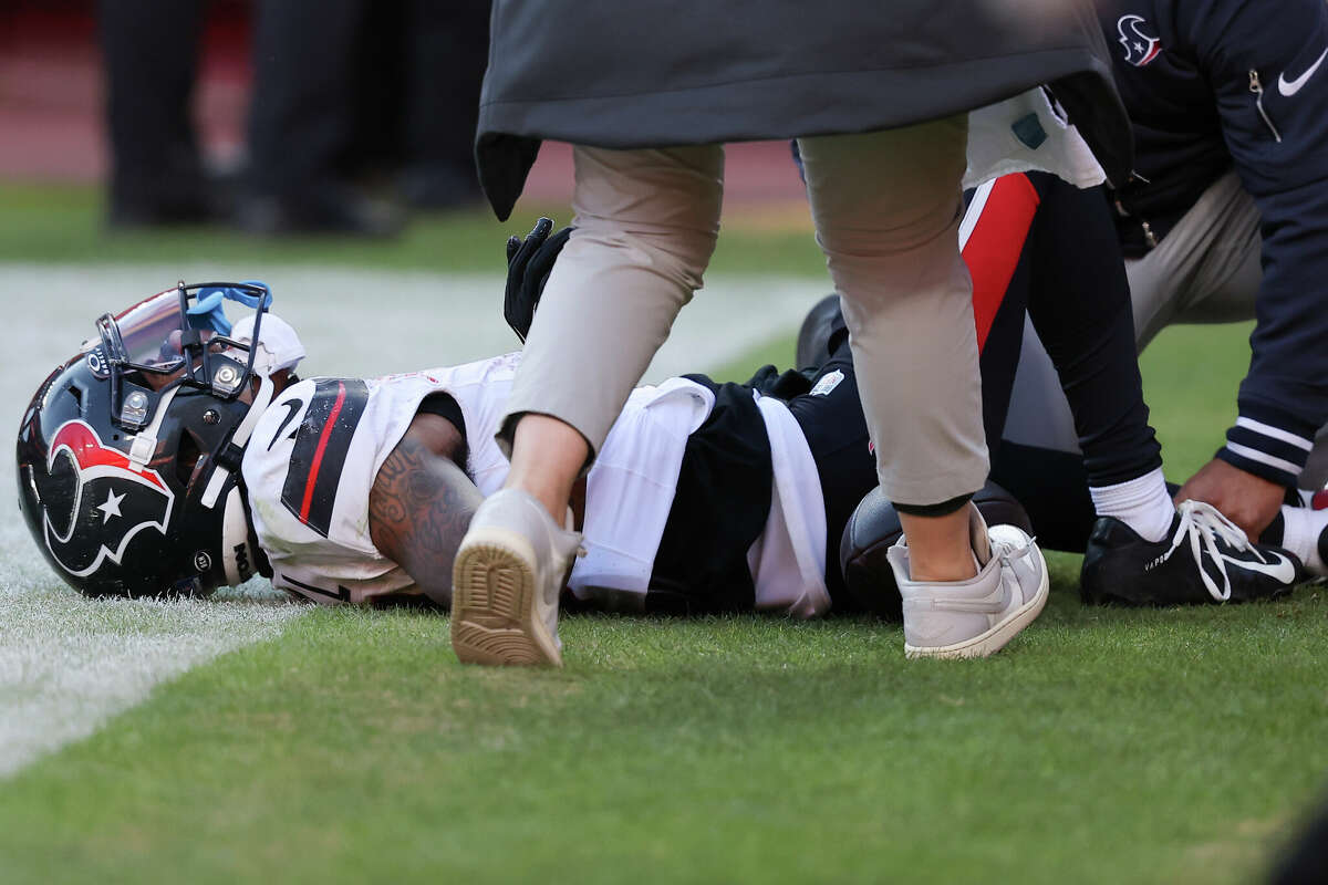 Medical staff look at Tank Dell #3 of the Houston Texans after Dell sustained an injury while catching a touchdown in the third quarter of a game against the Kansas City Chiefs at GEHA Field at Arrowhead Stadium on December 21, 2024 in Kansas City, Missouri. 