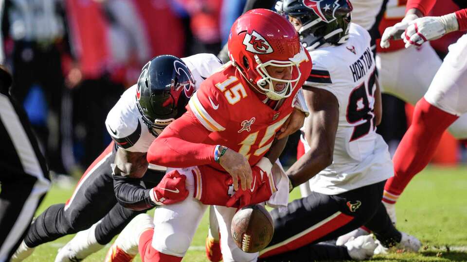 Houston Texans linebacker Christian Harris (48) sacks Kansas City Chiefs quarterback Patrick Mahomes (15) during the first half of an NFL football game Saturday, Dec. 21, 2024, in Kansas City.