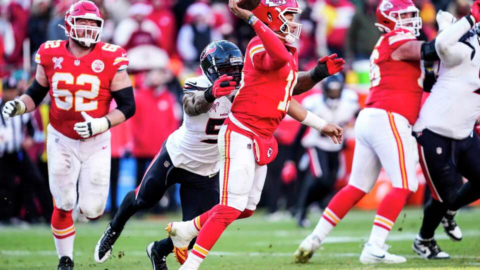 Kansas City Chiefs quarterback Patrick Mahomes (15) gets a pass off as he is pressured by Houston Texans defensive end Danielle Hunter (55) during the second half of an NFL football game Saturday, Dec. 21, 2024, in Kansas City.