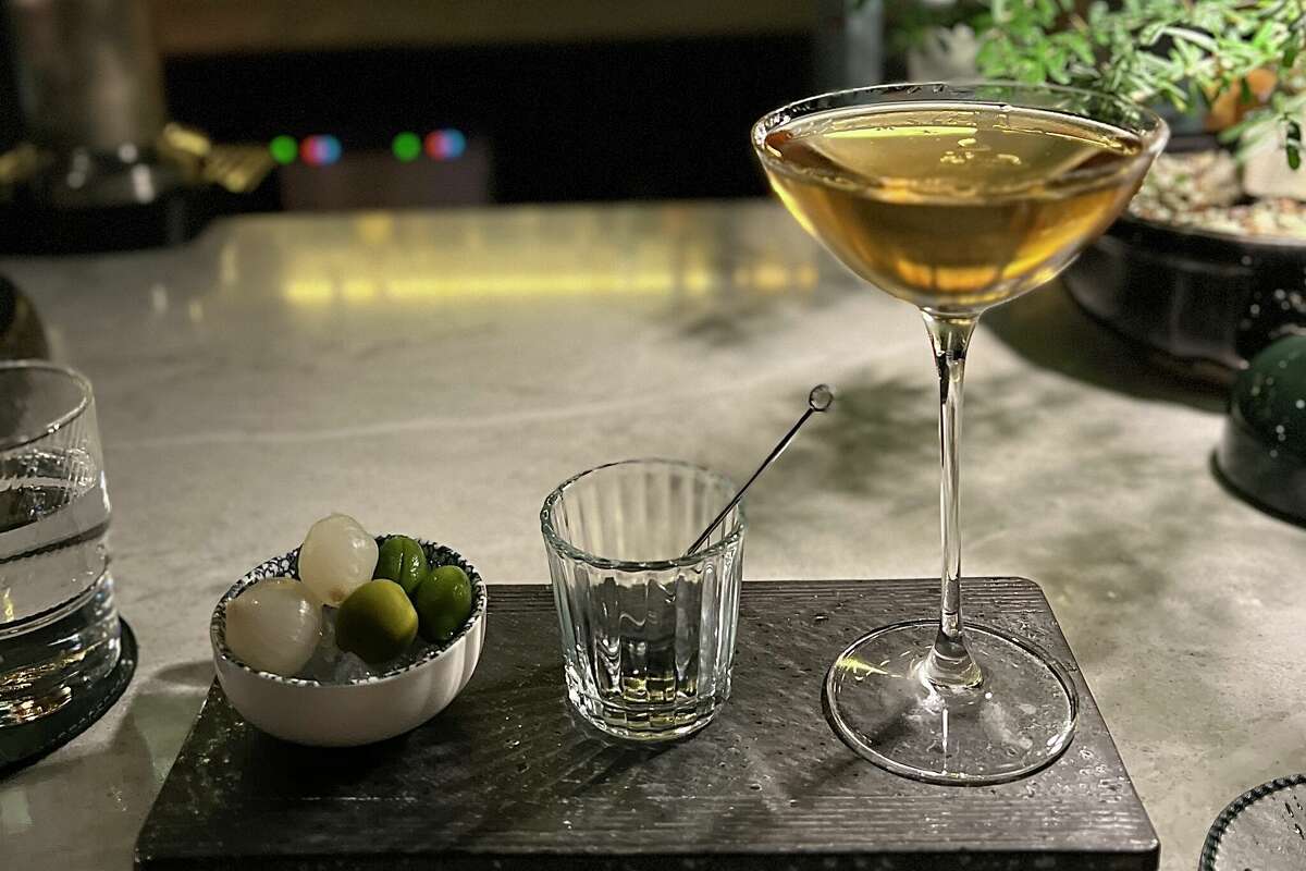 The umami martini alongside a bowl of Japanese peaches, olives, and pickled onions at Bar Doko.