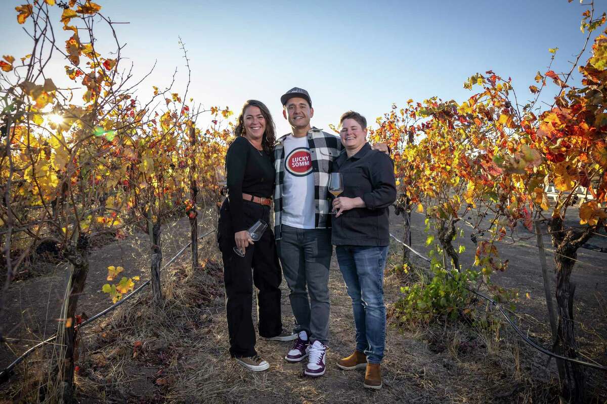 The revamped Band of Vintners, with the two new winemakers, Britt Nichols Richards, left, and Evyn Cameron, right, and new owner Desmond Echavarrie, center, in Napa, Calif., on Wednesday, November 6, 2024. Band of Vintners is a popular and rare value Cabernet brand (under $40), which sold to a Master Sommelier, formerly of the French Laundry, and has a fresh team of 'band members.’