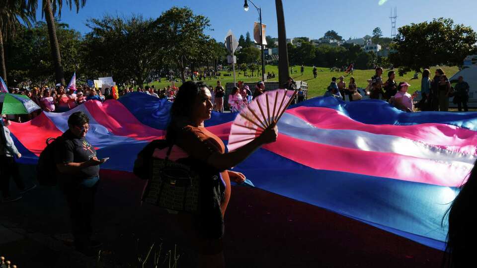 Antonella Delgado helps hold up a large transgender pride flag at the beginning of the Trans March from Dolores Park to Turk and Taylor streets in downtown San Francisco on Friday, June 28, 2024.