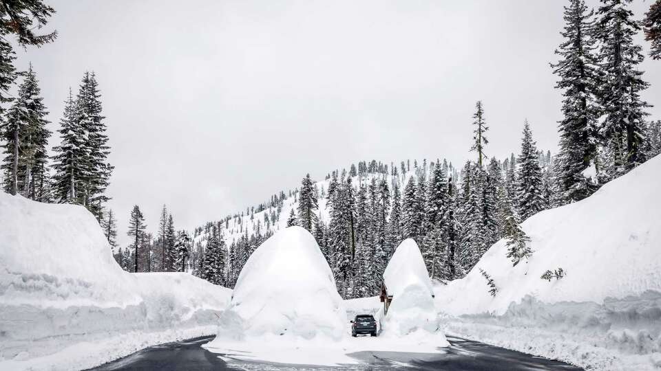 The entry kiosks at Lassen Volcanic National Park are covered in snow accumulation on Sunday, April 2, 2023. Historic snowfall in parts of California have left the state with more water than it’s used to, recharging aquifers, overflowing streams and resuscitating areas once bereft of water.