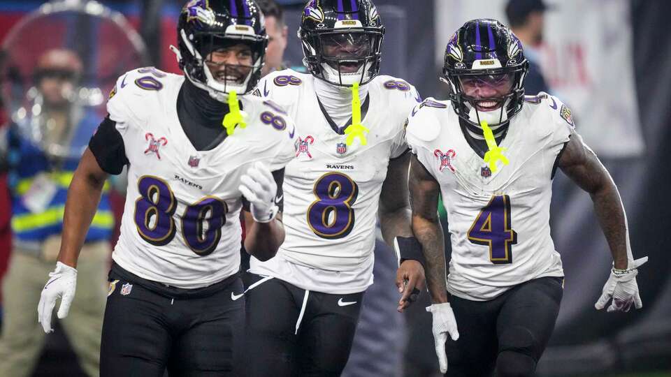 Baltimore Ravens tight end Isaiah Likely (80), quarterback Lamar Jackson (8) and wide receiver Zay Flowers (4) celebrate Jackson’s 48-yard touchdown run against the Houston Texans during the second half of an NFL football game Wednesday, Dec. 25, 2024, in Houston.