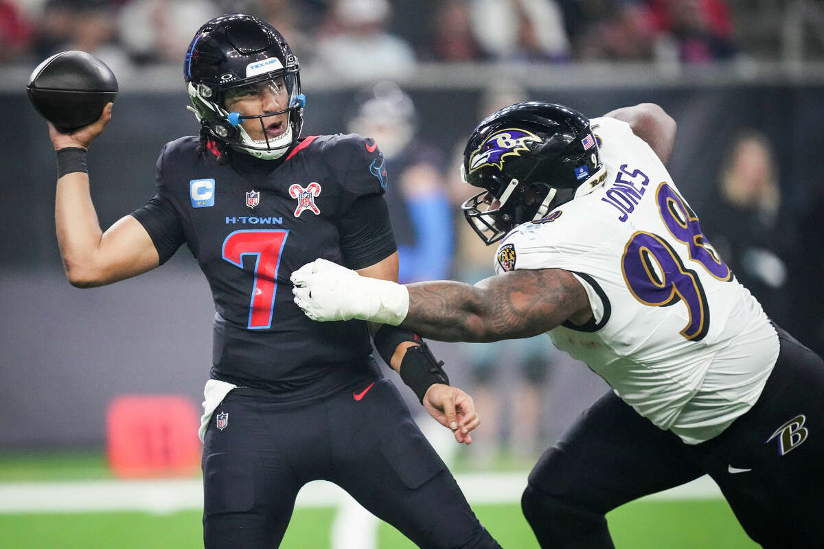 Houston Texans quarterback C.J. Stroud (7) is pressured by Baltimore Ravens defensive tackle Travis Jones (98) during the second half of an NFL football game Wednesday, Dec. 25, 2024, in Houston.