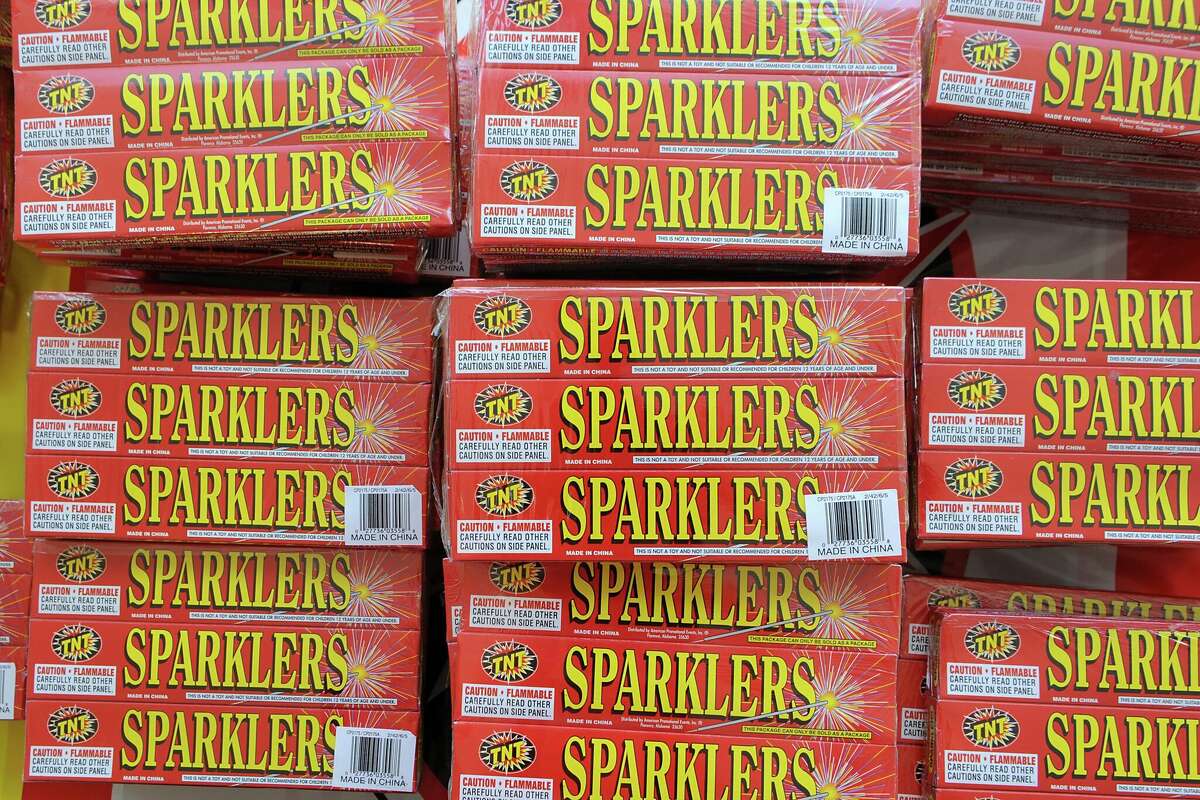 Packages of sparklers are displayed in a TNT Fireworks tent in New York. You can buy fireworks in Texas, but there are obstacles.