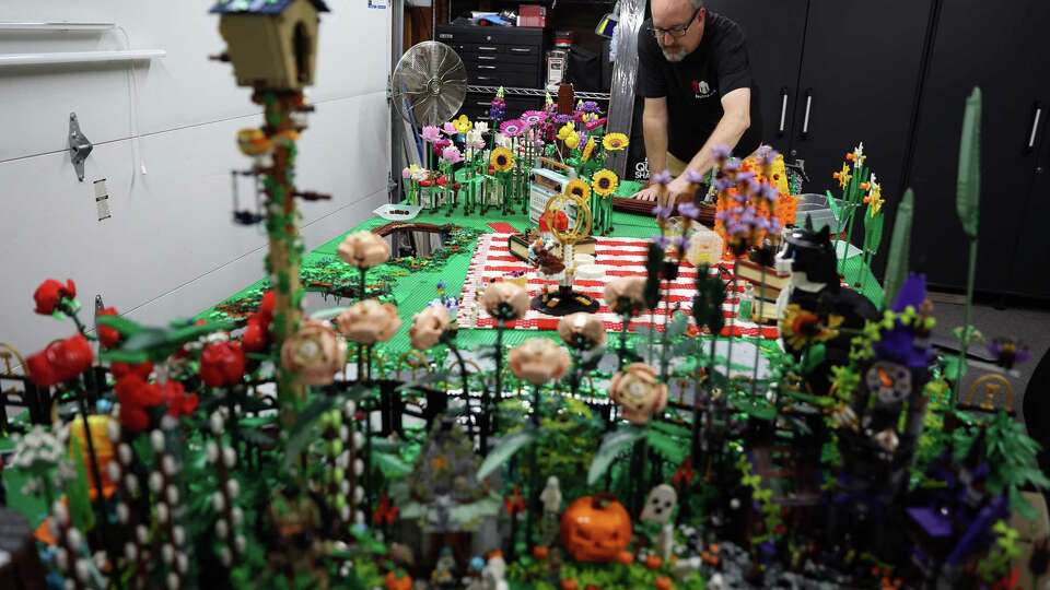 Dan Kees works on a Halloween Lego display in his Lego lab in their garage in San Jose on Sunday, October 27, 2024.