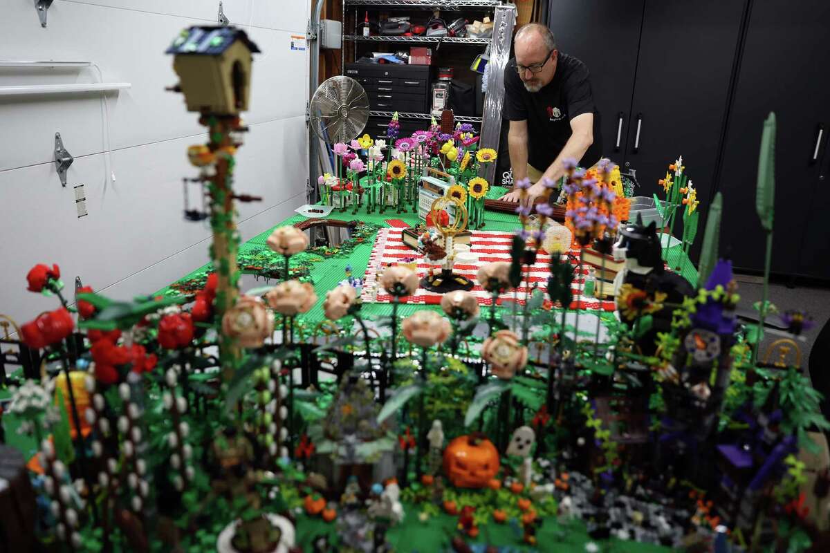 Dan Kees works on a Halloween Lego display in his Lego lab in their garage in San Jose on Sunday, October 27, 2024.