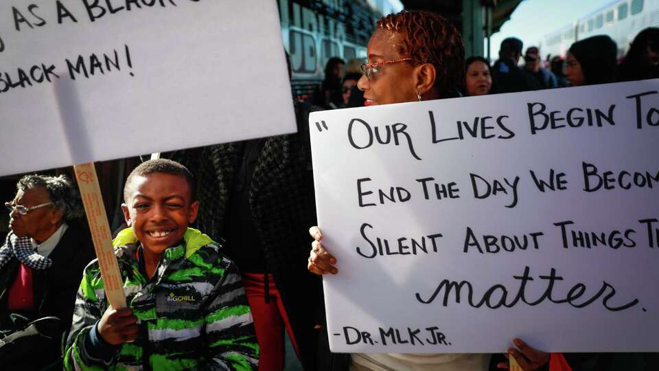 Clarissa Flippin (right) and grandson Domonic Hampton, 8, (left)walk from the Caltrain to participate in the MLK walk in San Francisco, California, on Monday, Jan. 21, 2019.